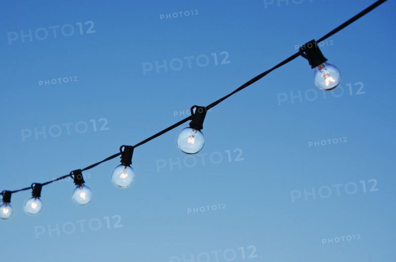 String of party lights against clear sky at twilight