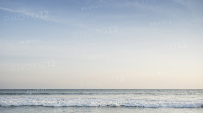 Pastel colored sky above calm Atlantic Ocean at dusk
