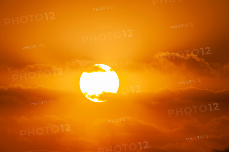 Sunrise passing though orange clouds. Boca Raton, Florida, United States