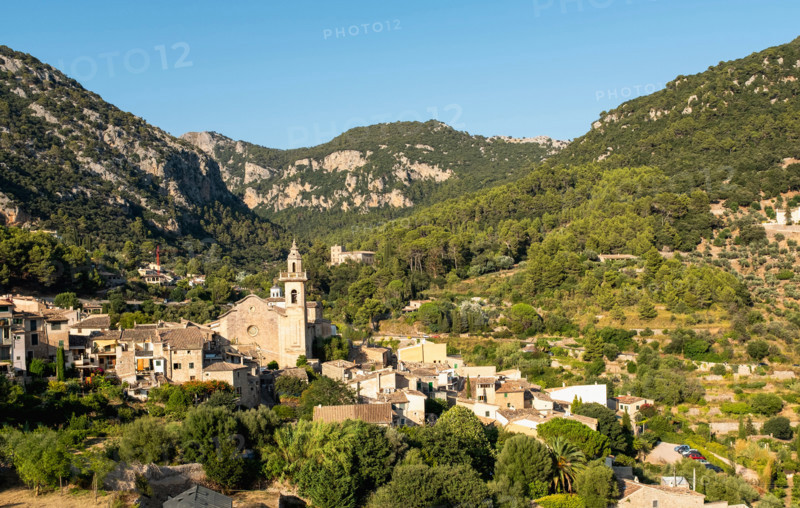 Old town in valley on sunny day. Valldemossa, Mallorca, Spain