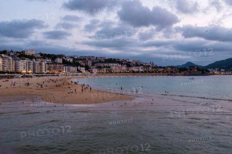 Tourists at Concha Beach at sunset. San Sebastian, Gipuzkoa, Spain