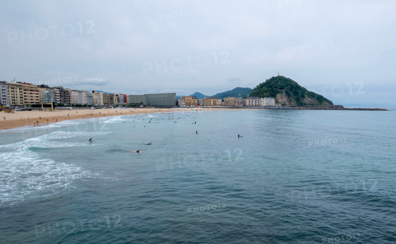 Tourists swimming and relaxing at Zurriola Beach. San Sebastian, Gipuzkoa, Spain