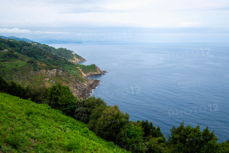 Green coastal hills and calm sea. San Sebastian, Gipuzkoa, Spain