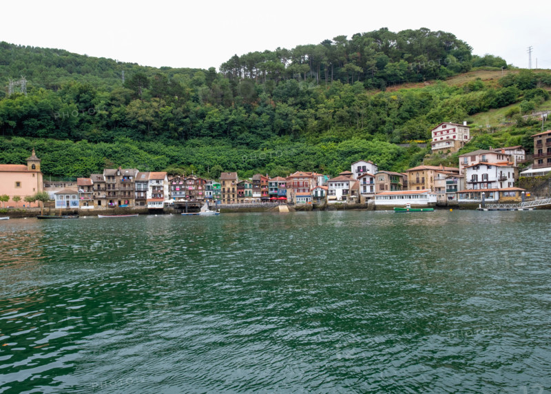 Fishing village seen across calm water. Pasaia, Gipuzkoa, Spain
