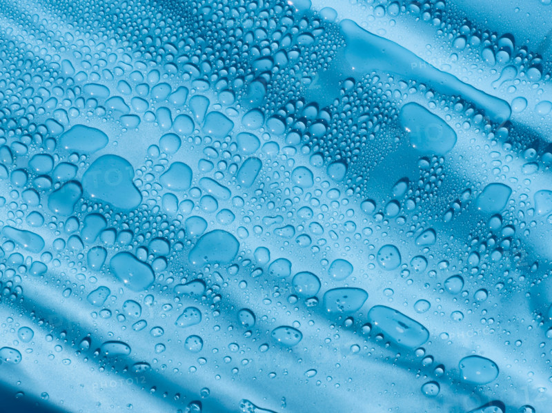 Water droplets on blue plastic tarpaulin. Nashville, Tennessee, United States