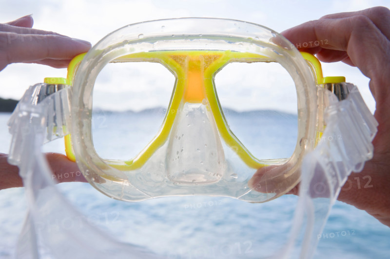 Close-up of hands holding dive mask. St. John, United States Virgin Islands, United States