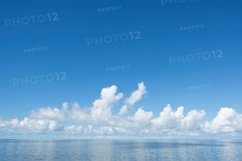 White puffy clouds over calm sea. Eastpoint, Florida, United States