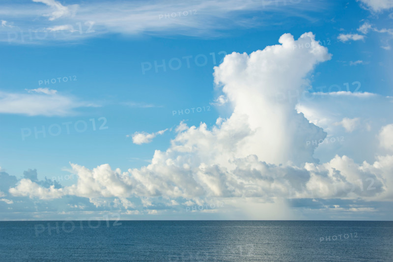 White puffy clouds over calm water. St. George Island, Florida, United States