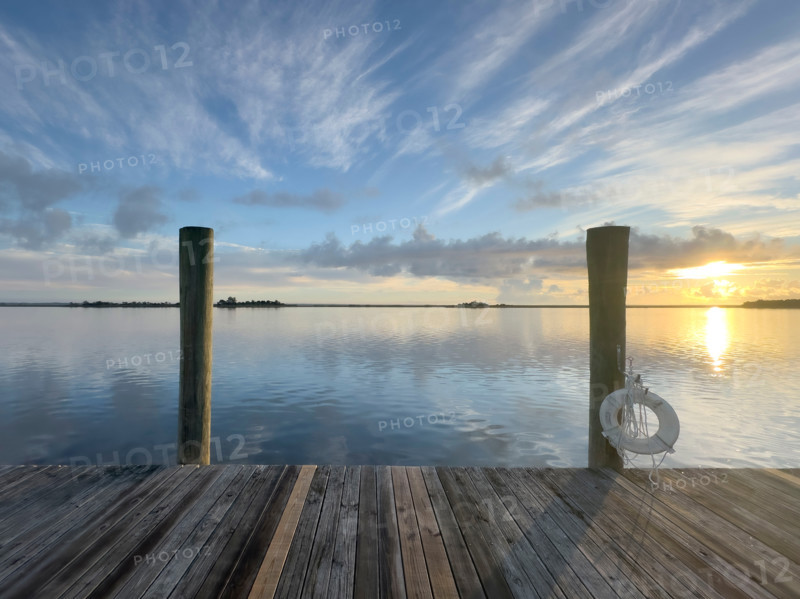 Wooden pier and calm water at sunrise. Apalachicola, Florida, United States