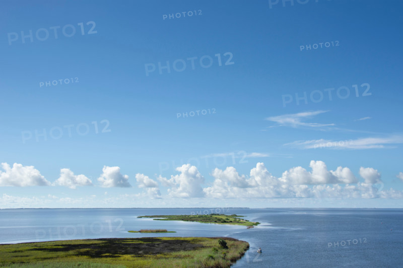 White clouds above calm Apalachicola Bay. Apalachicola, Florida, United States