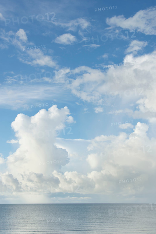 White puffy clouds over calm Gulf of Mexico. St. George Island, Florida, United States