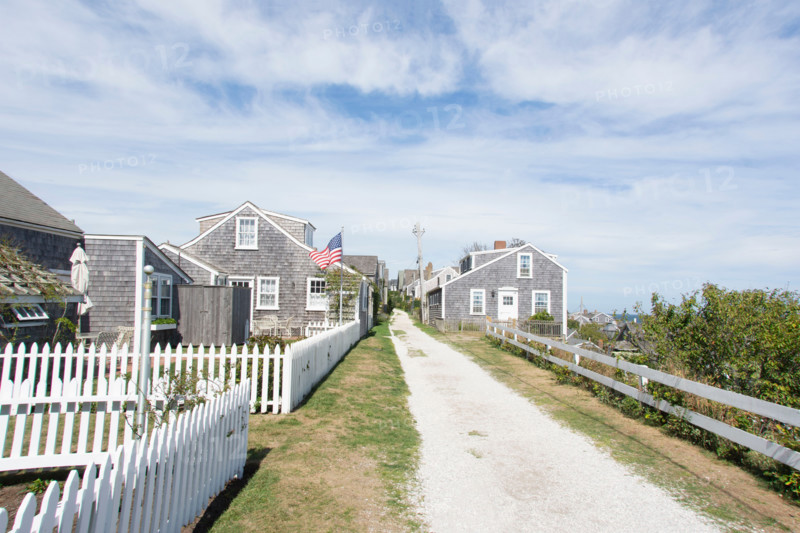 Empty dirt road and coastal houses. Nantucket, Massachusetts, United States