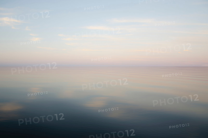 Defocused calm lake surface at sunrise. Pulaski, New York State, United States