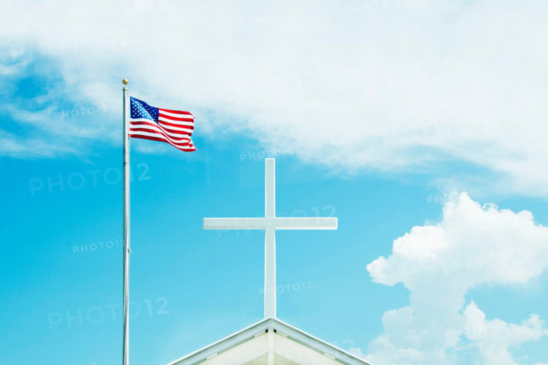 American flag and cross on top of church against sky. St. George Island, Florida, United States