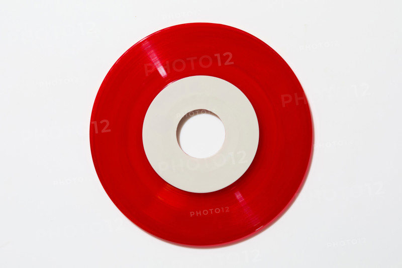 Red vinyl record on white background. New york City, New York State, United States