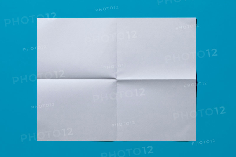 White sheet of paper on blue background. New York City, New York State, United States