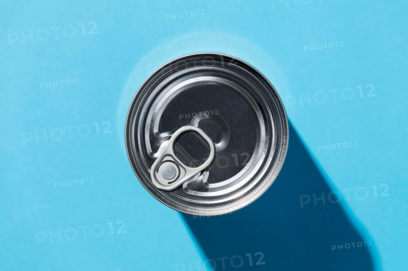 Overhead view of tin can on blue background. New York City, New York State, United States