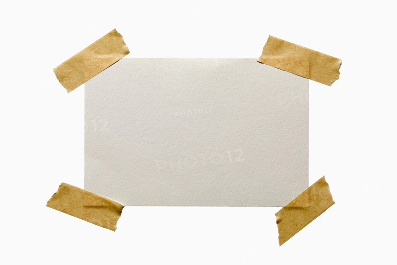 Blank textured paper taped on white background. New York City, New York State, United States