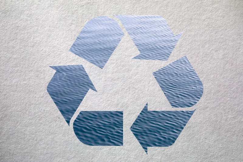 Blue recycling symbol on textured background. New York City, New York State, United States