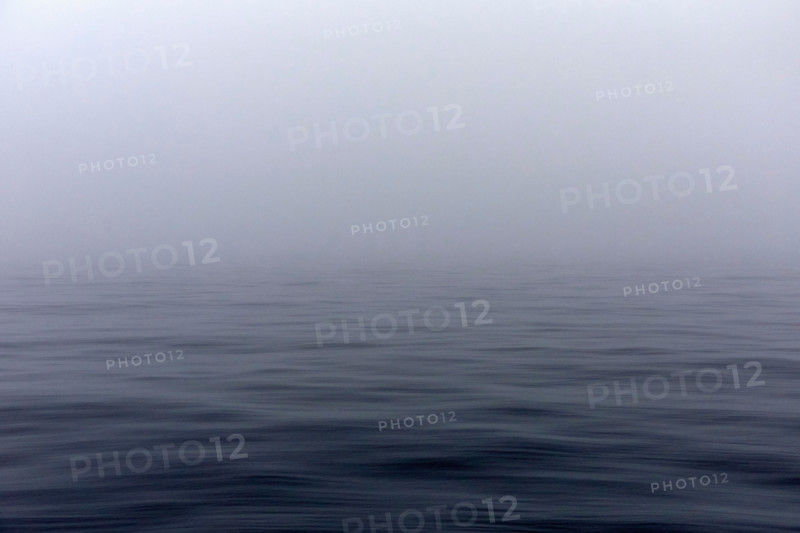 Calm Pacific Ocean in fog. Kodiak, Alaska, United States