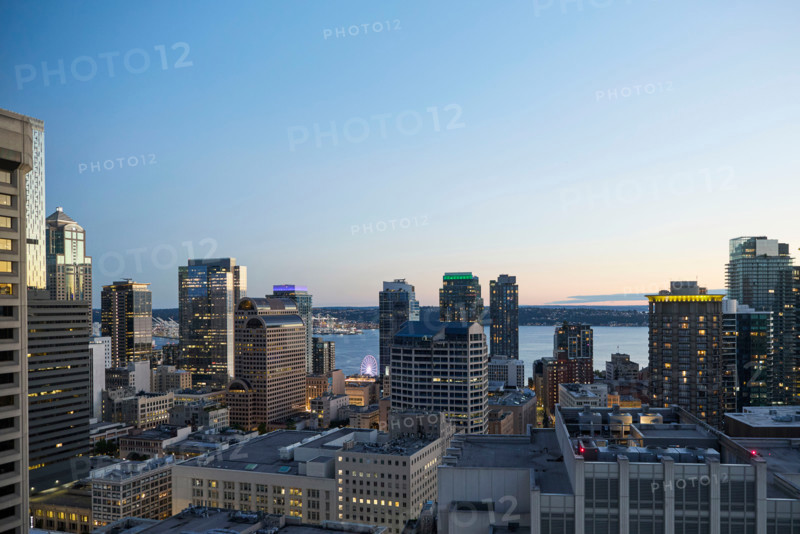 Downtown buildings illuminated at dusk. Seattle, Washington, United States