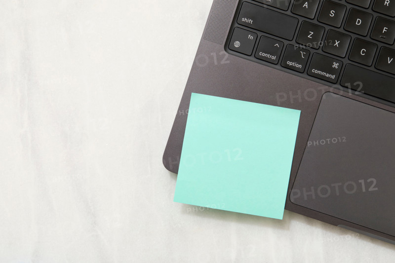 Blank green post it note on laptop. New York City, New York State, United States
