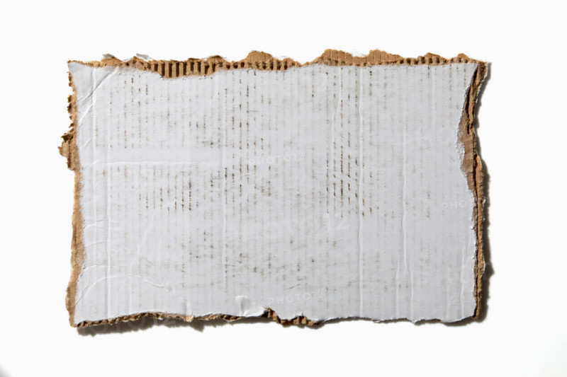 Torn white cardboard on white background. New York City, New York State, United States