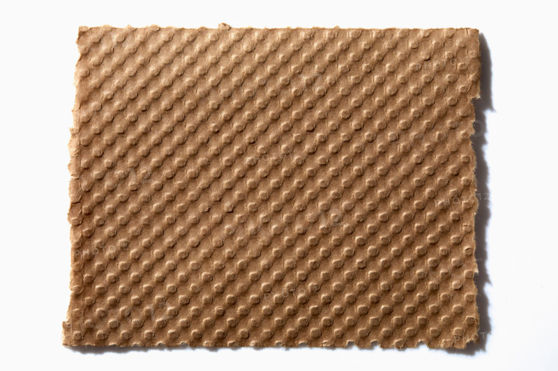 Torn corrugated cardboard on white background. New York City, New York State, United States