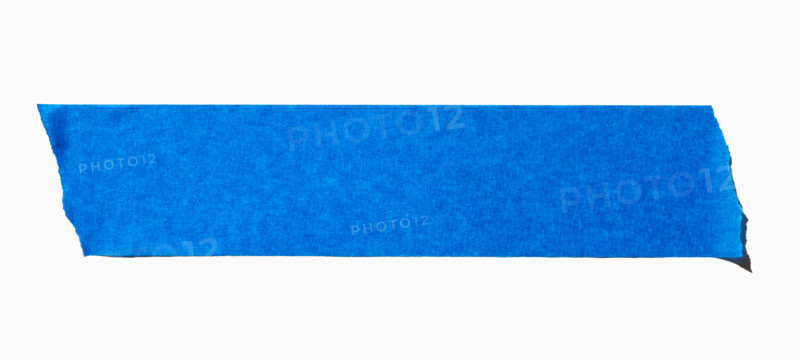 Ripped blue painters tape on white background. New York City, New York State, United States