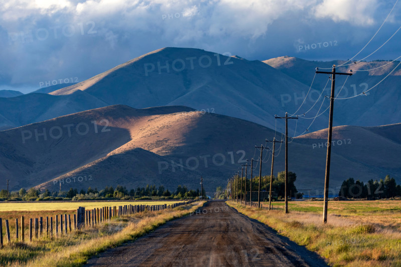 Empty rural road leading to foothills. Bellevue, Idaho, United States