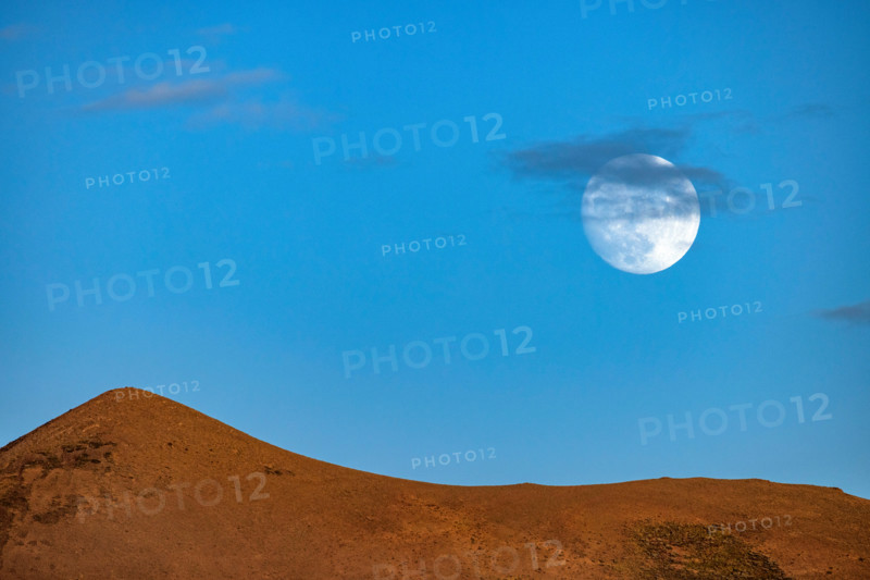 Full moon against blue sky over hills. Bellevue, Idaho, United States