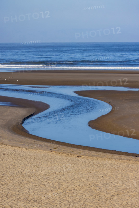S-shaped Ecola Creek flowing into Pacific Ocean. Cannon Beach, Oregon, United States
