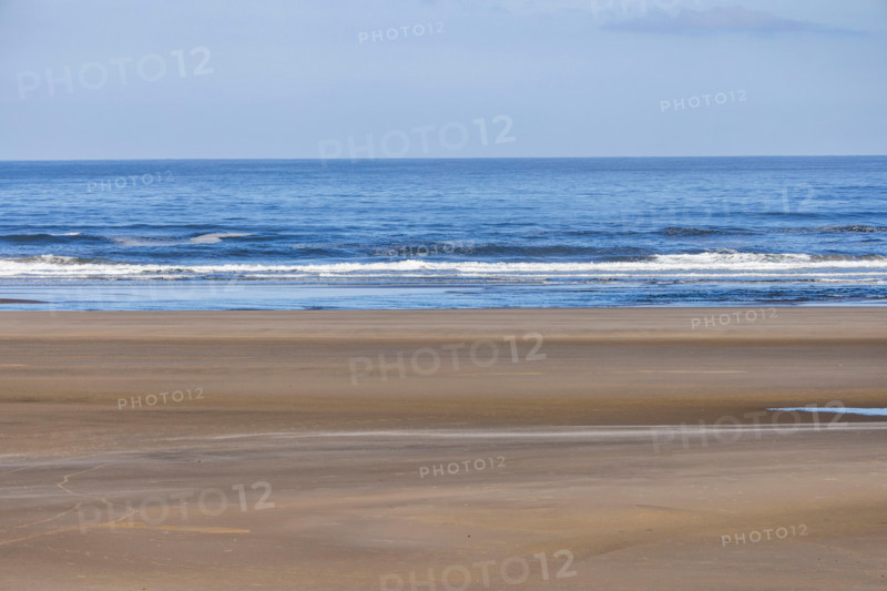 Empty beach and calm ocean at dawn. Cannon Beach, Oregon, United States