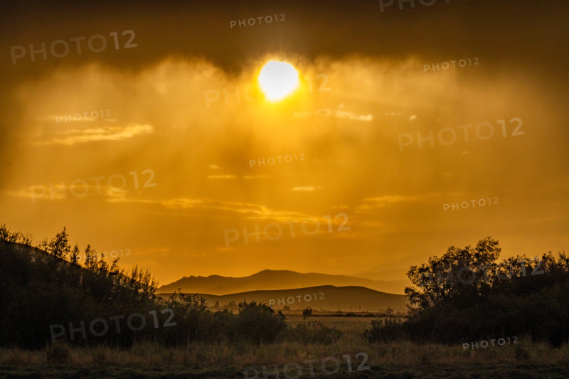 Sun below heavy rain clouds. Bellevue, Idaho, United States