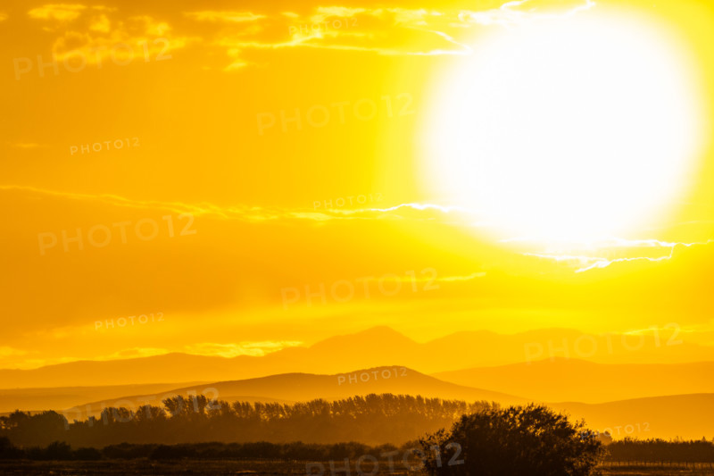 Setting sun glowing above hills. Bellevue, Idaho, United States