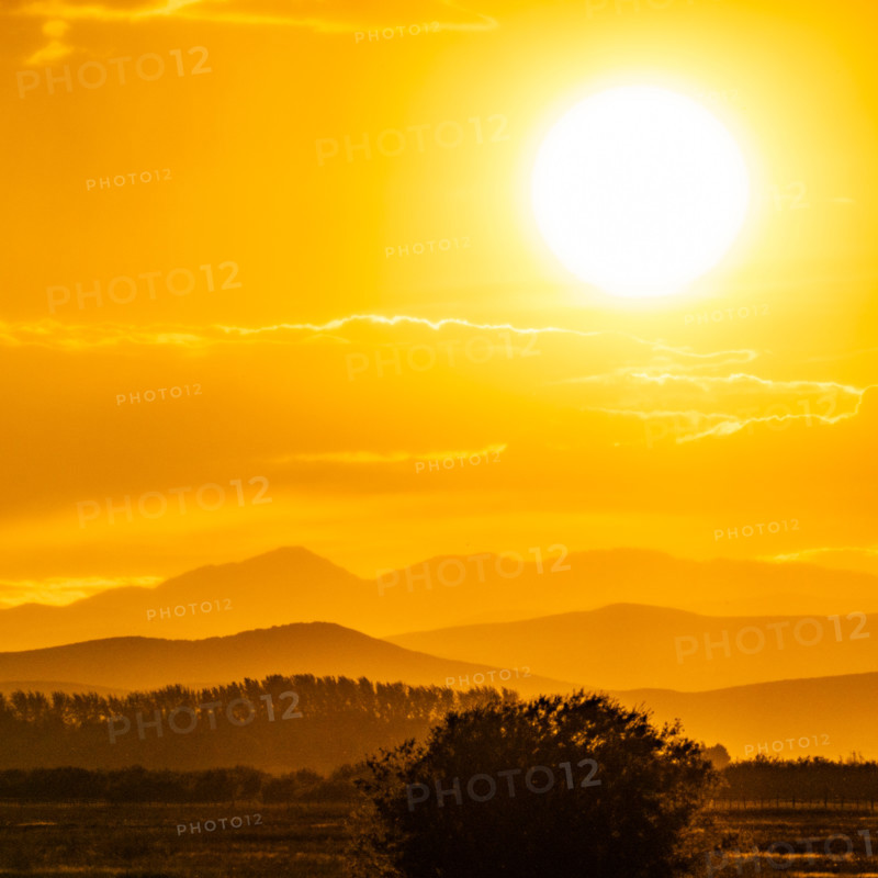Setting sun glowing above hills. Bellevue, Idaho, United States