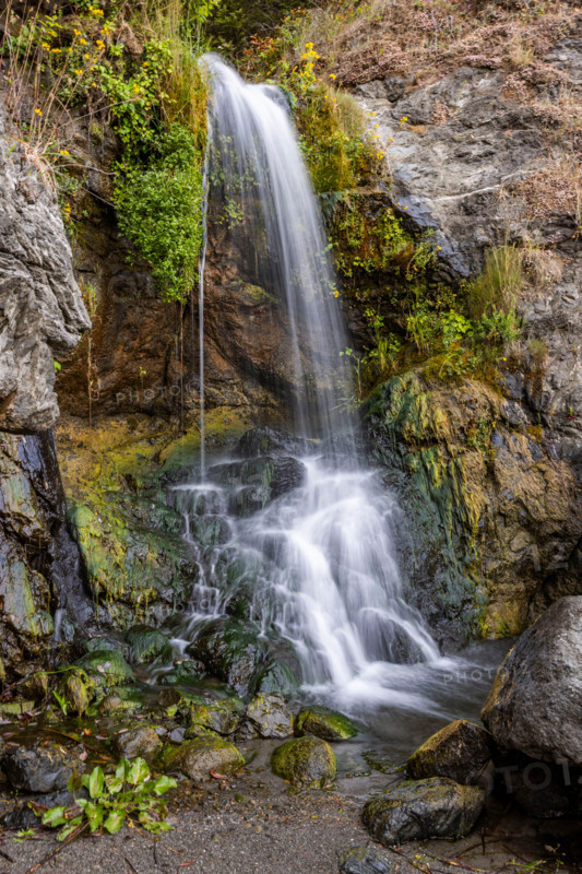 Waterfall running onto beach on Oregon Coast. Gold Beach, Oregon, United States