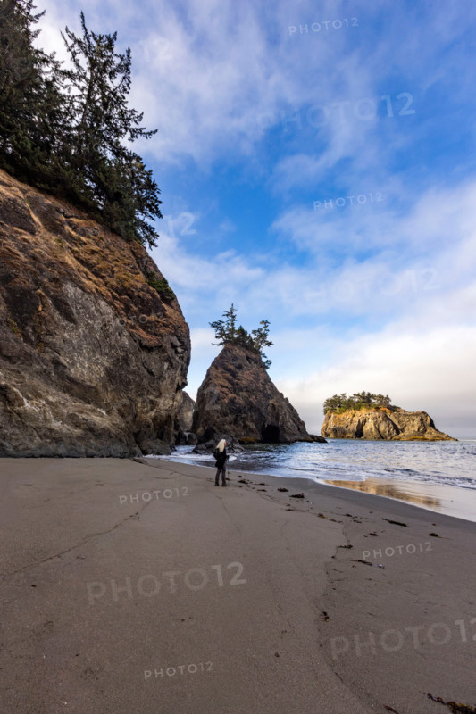 Woman on beach along Oregon Coast. Gold Beach, Oregon, United States