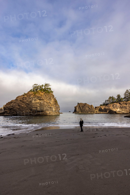 Woman on beach along Oregon Coast. Gold Beach, Oregon, United States