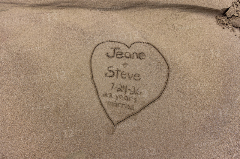 Anniversary message in sand along Oregon Coast. Gold Beach, Oregon, United States