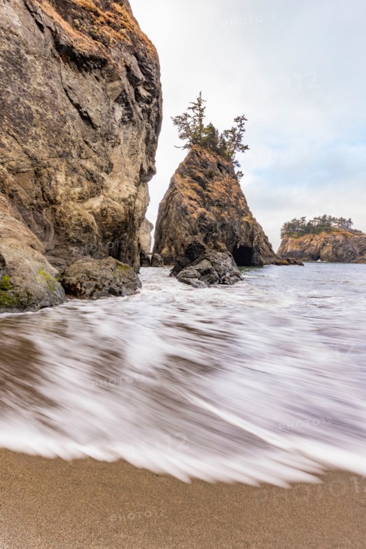 Tide rises by sea stacks on Oregon Coast, blurred ocean. Gold Beach, Oregon, United States