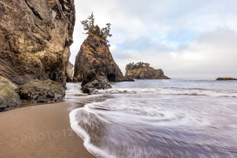 Tide rises by sea stacks on Oregon Coast, blurred ocean. Gold Beach, Oregon, United States