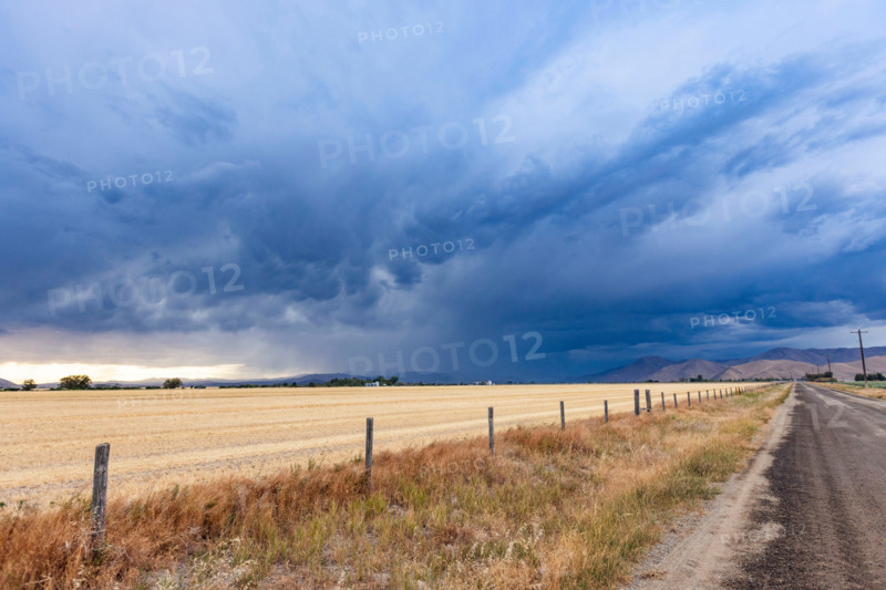 Storm clouds over fields and rural road. Bellevue, Idaho, United States