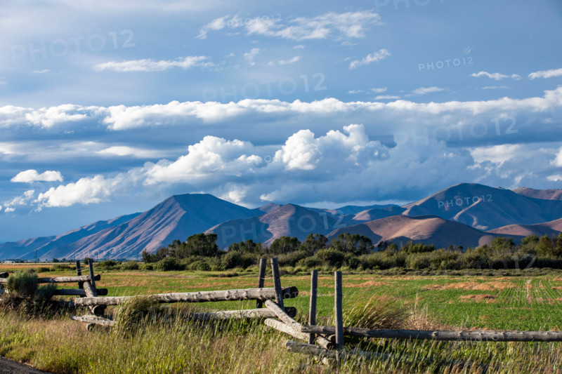 Fence in field with hills in background. Bellevue, Idaho, United States