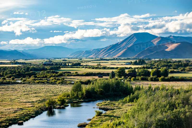 Silver Creek crossing field with hills in background. Bellevue, Idaho, United States