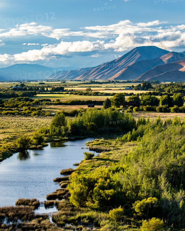 Silver Creek crossing field with hills in background. Bellevue, Idaho, United States
