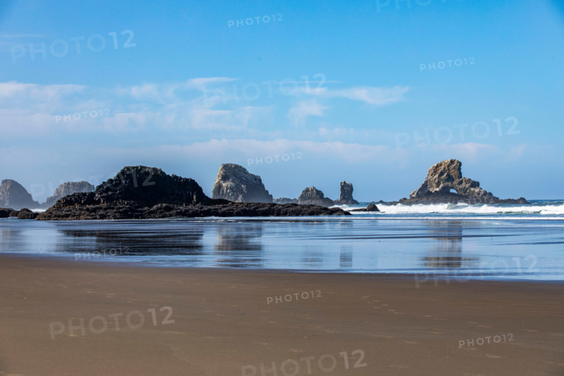 Calm ocean and rock formations on Oregon Coast. Cannon Beach, Oregon, United States