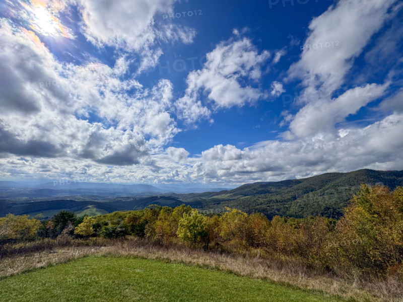 White puffy clouds over green fields and hills. Blacksburg, Virginia, United States