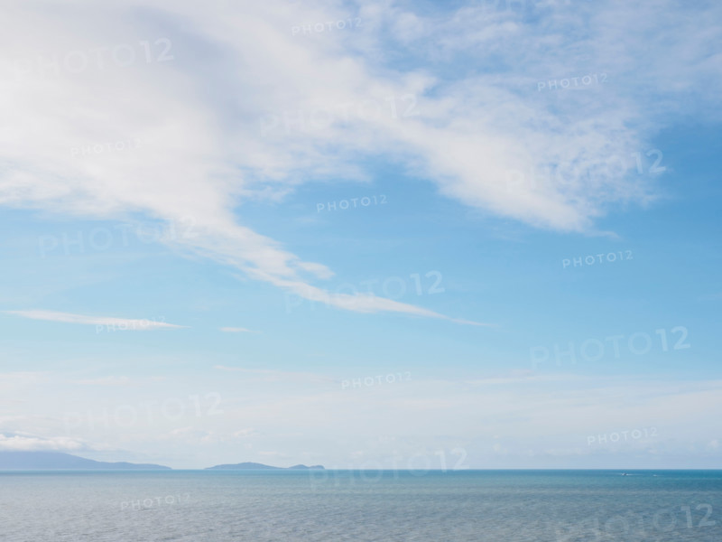 White delicate clouds above calm sea. Port Douglas, Queensland, Australia