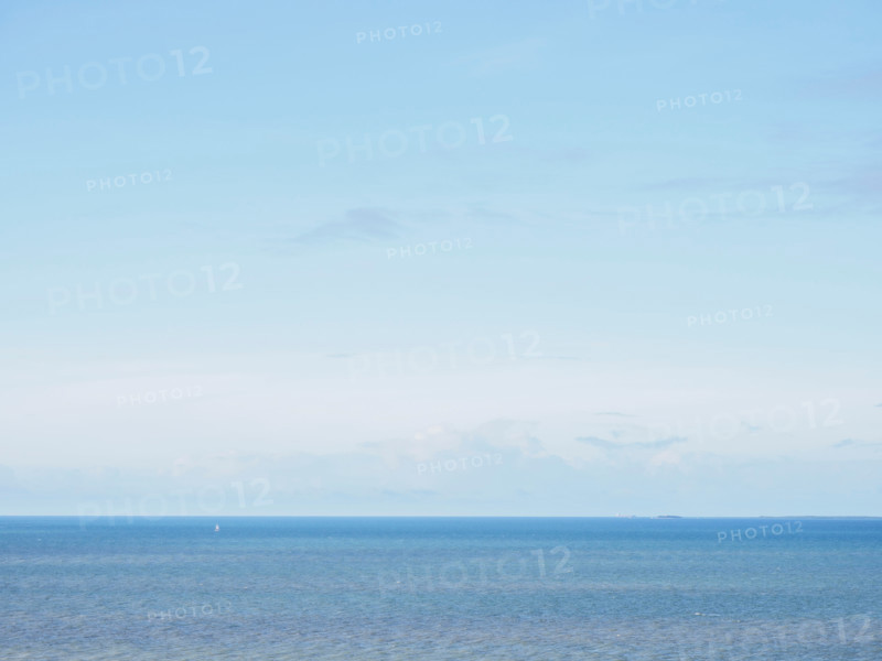 Clear light blue sky above calm sea. Port Douglas, Queensland, Australia